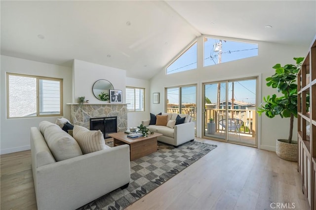 1709 Wollacott St, Redondo Beach, CA 90278 - living room with wood finished floors, a stone fireplace, vaulted ceiling, and baseboards
