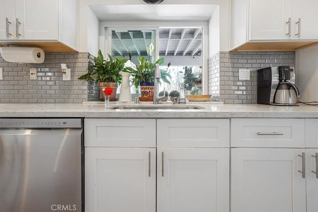 11025 Shaw St, Rancho Cucamonga, CA 91701 - kitchen with stainless steel dishwasher, white cabinets, decorative backsplash, and light stone countertops