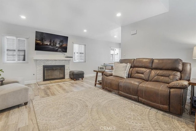 11025 Shaw St, Rancho Cucamonga, CA 91701 - living room featuring wood finished floors, recessed lighting, and a glass covered fireplace