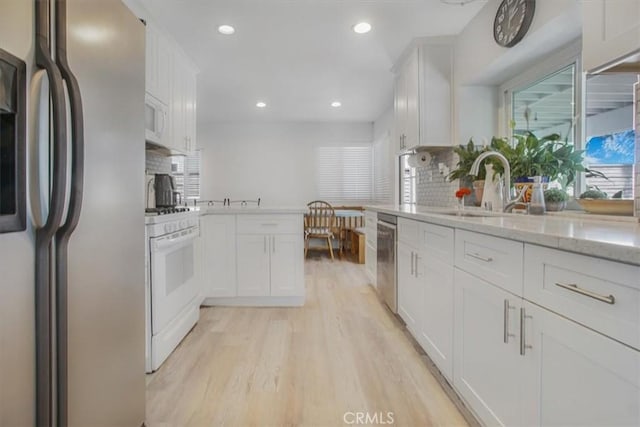 11025 Shaw St, Rancho Cucamonga, CA 91701 - kitchen with white appliances, recessed lighting, tasteful backsplash, and white cabinets