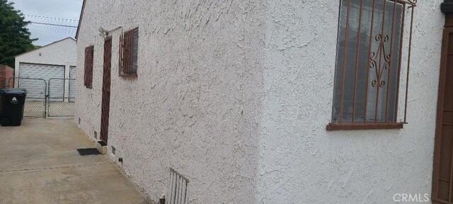7819 Dalton Ave, Los Angeles, CA 90047 - view of property exterior with stucco siding and a gate