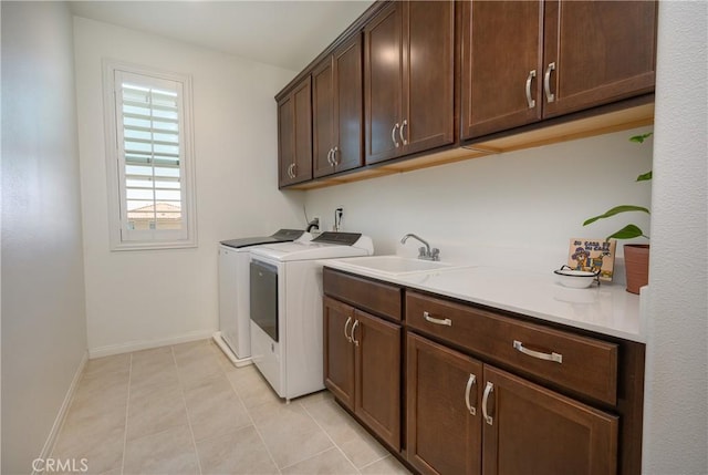 34197 Helenium St, Murrieta, CA 92563 - laundry area featuring washing machine and dryer, cabinet space, baseboards, and light tile patterned flooring