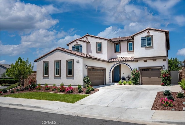 34197 Helenium St, Murrieta, CA 92563 - mediterranean / spanish house featuring stucco siding, a tiled roof, an attached garage, and concrete driveway
