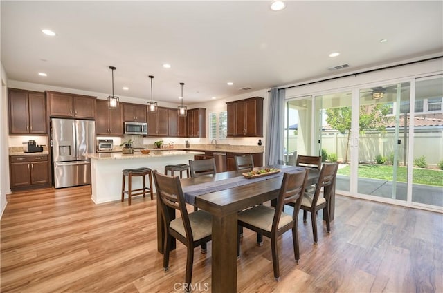 34197 Helenium St, Murrieta, CA 92563 - dining area with light wood-type flooring and recessed lighting