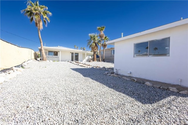 66691 Flora Ave, Desert Hot Springs, CA 92240 - back of house featuring stucco siding