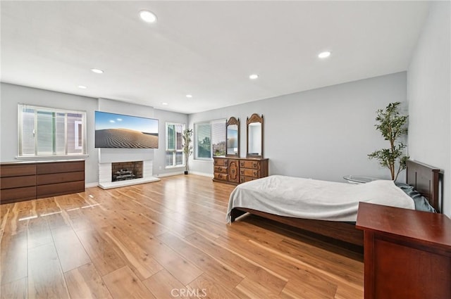 9256 Crocus Ave, Fountain Valley, CA 92708 - bedroom with light wood finished floors, recessed lighting, and a fireplace with raised hearth