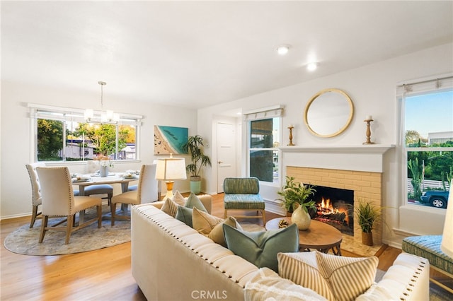 1357 Curtis Ave, Manhattan Beach, CA 90266 - living room featuring light wood finished floors, a fireplace, a chandelier, and baseboards