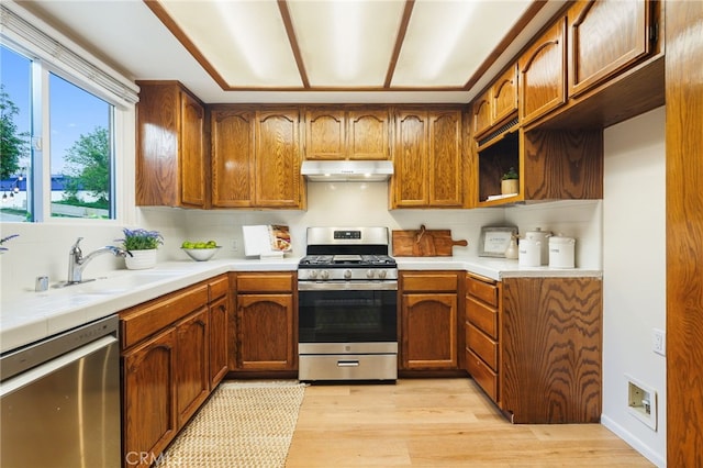1357 Curtis Ave, Manhattan Beach, CA 90266 - kitchen featuring stainless steel appliances, under cabinet range hood, light wood-style floors, and brown cabinets