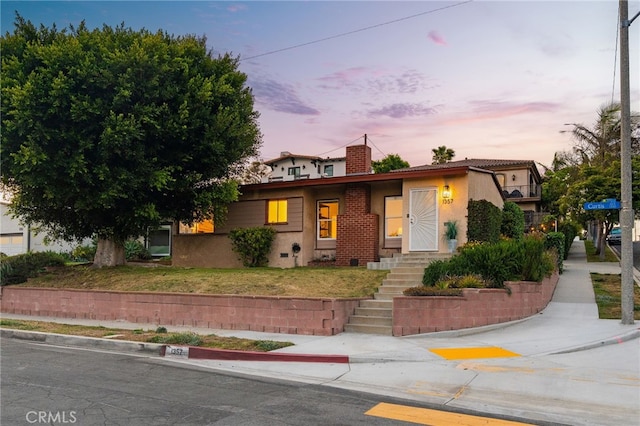 1357 Curtis Ave, Manhattan Beach, CA 90266 - view of front of home with stucco siding, a chimney, and stairway