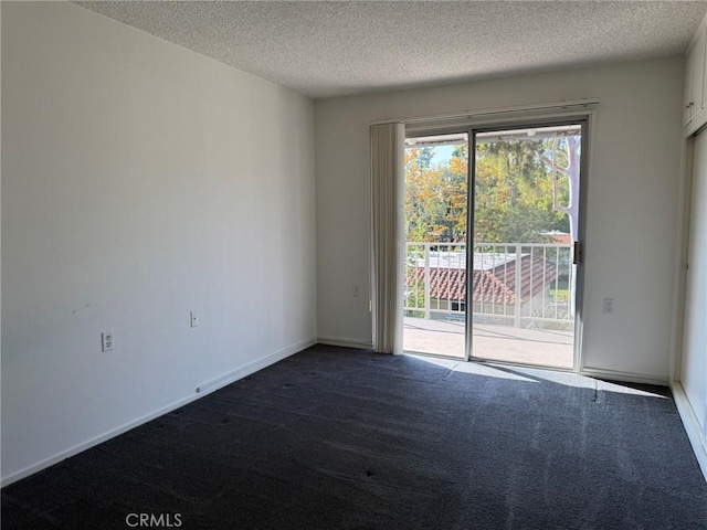 680 Via Alhambra Unit O, Laguna Woods, CA 92637 - unfurnished room featuring dark carpet, a textured ceiling, and baseboards
