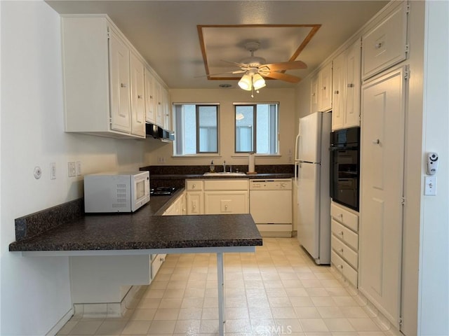 680 Via Alhambra Unit O, Laguna Woods, CA 92637 - kitchen with white appliances, a peninsula, under cabinet range hood, a ceiling fan, and dark countertops