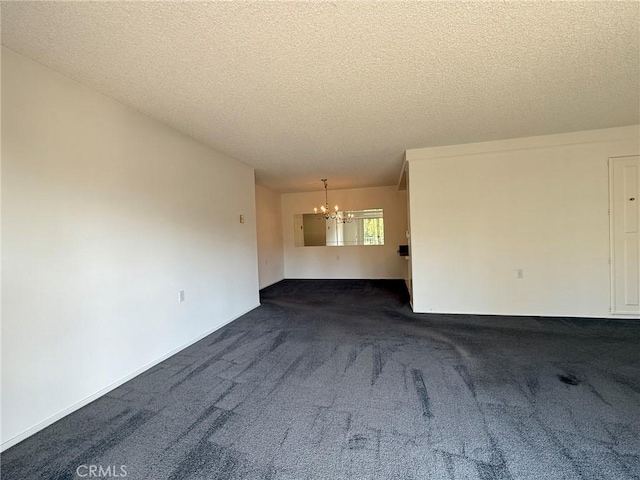 680 Via Alhambra Unit O, Laguna Woods, CA 92637 - unfurnished living room with a chandelier, a textured ceiling, and dark carpet