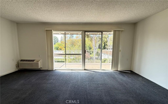 680 Via Alhambra Unit O, Laguna Woods, CA 92637 - empty room with plenty of natural light, a wall mounted AC, dark carpet, and a textured ceiling