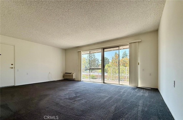 680 Via Alhambra Unit O, Laguna Woods, CA 92637 - unfurnished room featuring dark carpet, a wall mounted air conditioner, and a textured ceiling
