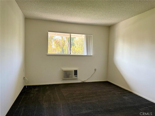 680 Via Alhambra Unit O, Laguna Woods, CA 92637 - carpeted empty room featuring a wall mounted air conditioner and a textured ceiling