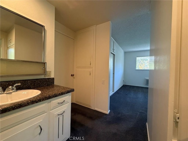 680 Via Alhambra Unit O, Laguna Woods, CA 92637 - bathroom featuring vanity and a textured ceiling