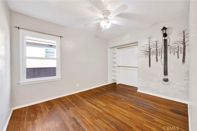 14124 Sayre St, Sylmar, CA 91342 - unfurnished bedroom with baseboards, wood finished floors, a ceiling fan, and a closet