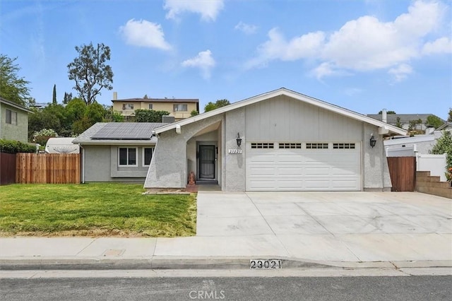 23021 Posada Dr, Valencia, CA 91354 - view of front facade featuring a garage, solar panels, driveway, and stucco siding
