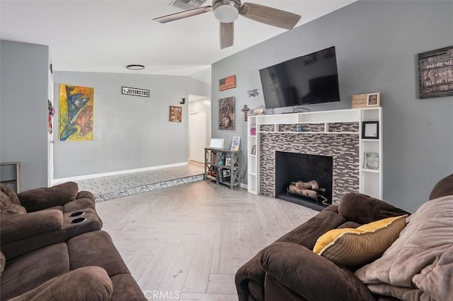 23021 Posada Dr, Valencia, CA 91354 - living room featuring a ceiling fan, a tiled fireplace, and baseboards