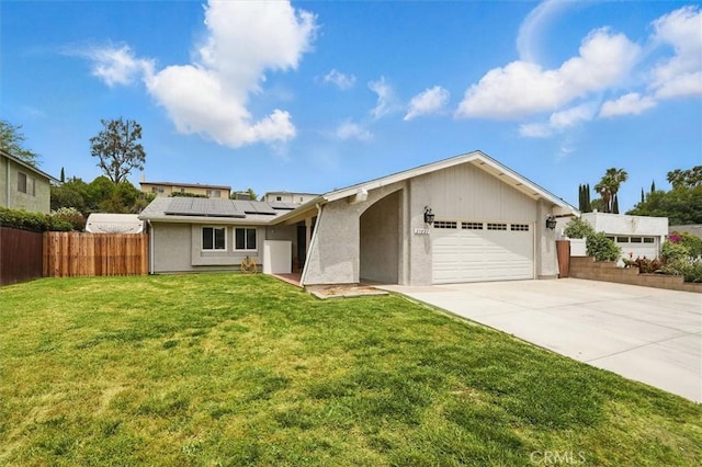 23021 Posada Dr, Valencia, CA 91354 - view of front of home featuring an attached garage, roof mounted solar panels, driveway, and stucco siding