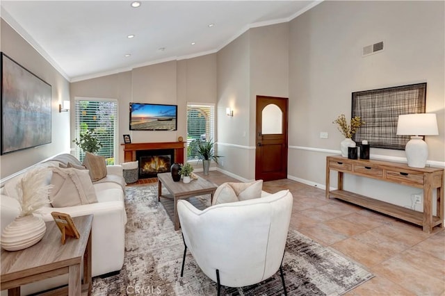 3531 Almond St, Irvine, CA 92606 - living room with a warm lit fireplace, high vaulted ceiling, baseboards, recessed lighting, and crown molding