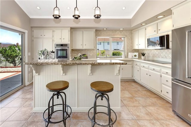3531 Almond St, Irvine, CA 92606 - kitchen with appliances with stainless steel finishes, decorative backsplash, white cabinets, ornamental molding, and recessed lighting