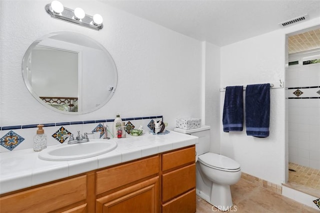 2922 Estancia, San Clemente, CA 92673 - full bathroom with vanity, tiled shower, toilet, and tile patterned floors