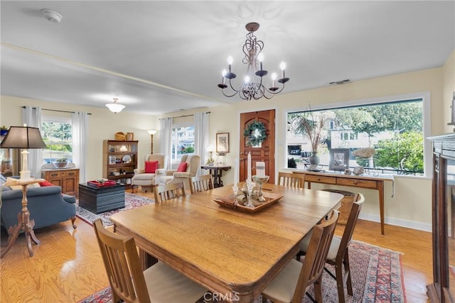 2309 E Glenoaks Blvd, Glendale, CA 91206 - dining space featuring light wood finished floors, plenty of natural light, a chandelier, and baseboards
