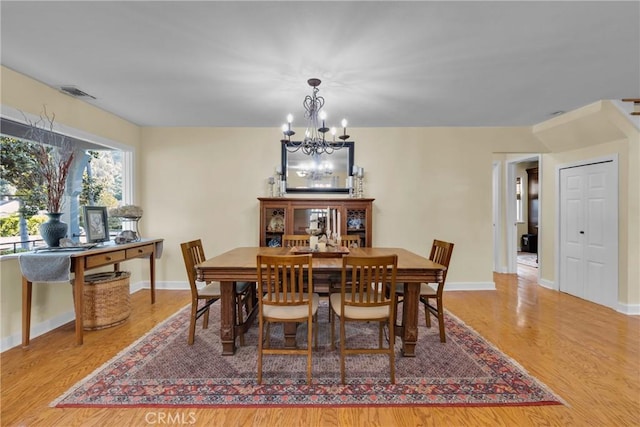 2309 E Glenoaks Blvd, Glendale, CA 91206 - dining room with a chandelier, wood finished floors, and baseboards
