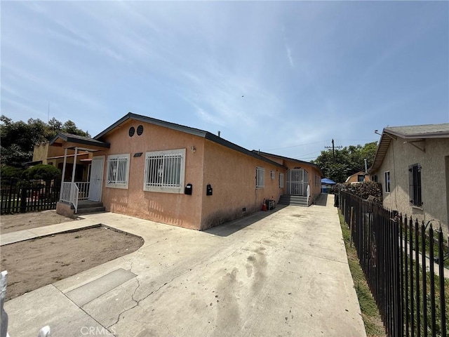 9815 Holmes Ave Unit 2, Los Angeles, CA 90002 - view of front of house featuring stucco siding and crawl space