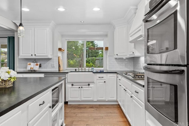 856 Oro Grande St, Oceanside, CA 92057 - kitchen with appliances with stainless steel finishes, a sink, dark countertops, light wood finished floors, and recessed lighting