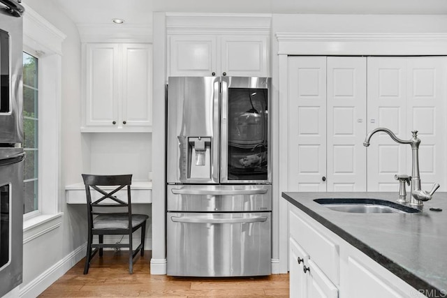 856 Oro Grande St, Oceanside, CA 92057 - kitchen with stainless steel fridge with ice dispenser, a sink, white cabinetry, light wood-style floors, and recessed lighting