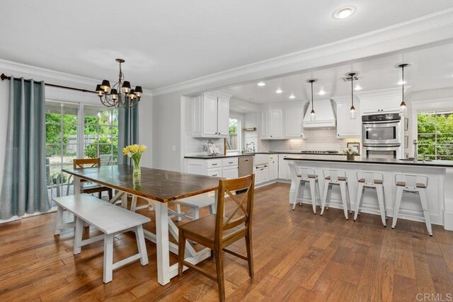 856 Oro Grande St, Oceanside, CA 92057 - dining space with a chandelier, crown molding, dark wood-style floors, and recessed lighting