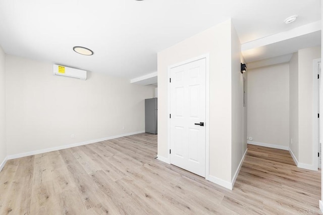 49694971-4973 N 72nd St, San Diego, CA 92115 - finished below grade area featuring a wall unit AC, light wood-style flooring, freestanding refrigerator, and baseboards