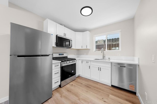 49694971-4973 N 72nd St, San Diego, CA 92115 - kitchen with stainless steel appliances, a sink, light wood finished floors, white cabinets, and light countertops