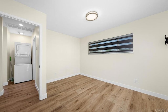49694971-4973 N 72nd St, San Diego, CA 92115 - unfurnished room with stacked washing machine and dryer, wood finished floors, and baseboards