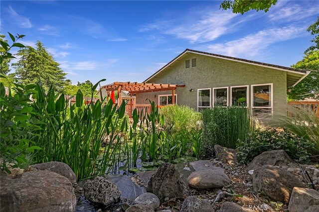 13 Avante Way, Chico, CA 95973 - view of home's exterior with stucco siding, a pergola, and a tile roof