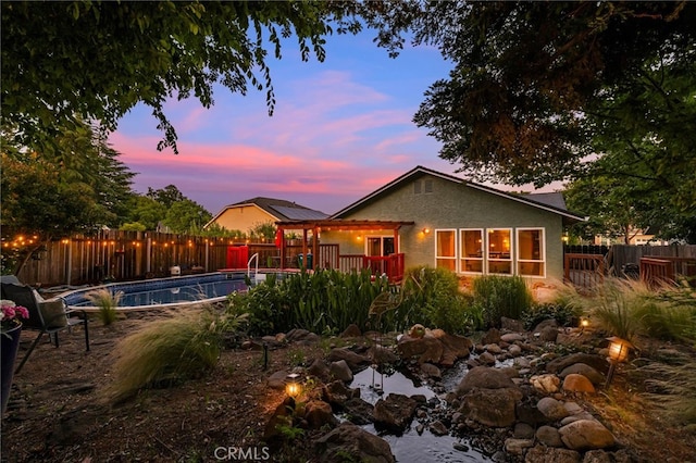 13 Avante Way, Chico, CA 95973 - back of house with a fenced backyard, stucco siding, and a wooden deck