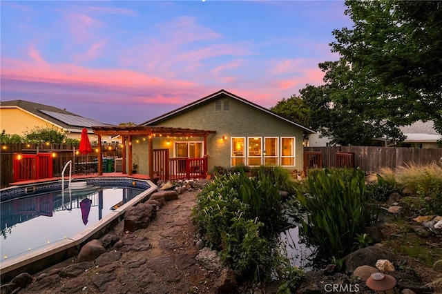 13 Avante Way, Chico, CA 95973 - back of house featuring a fenced backyard, an outdoor pool, stucco siding, and a wooden deck