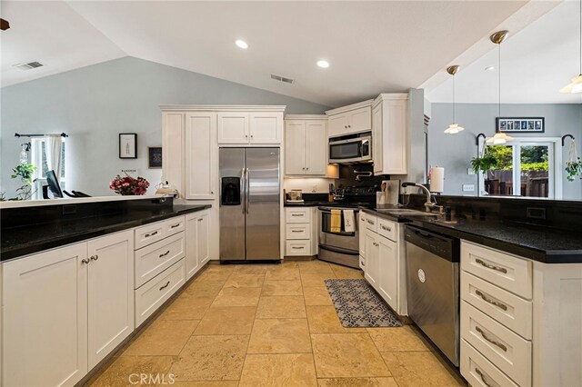 13 Avante Way, Chico, CA 95973 - kitchen featuring stainless steel appliances, a peninsula, lofted ceiling, a sink, and dark countertops