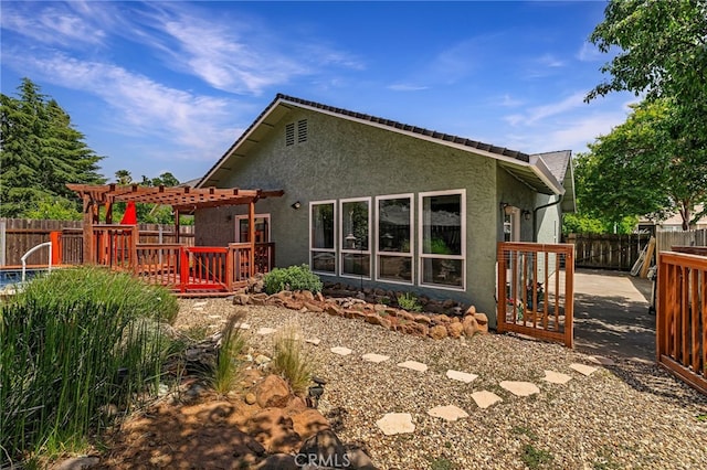 13 Avante Way, Chico, CA 95973 - rear view of property featuring stucco siding, a fenced backyard, and a pergola