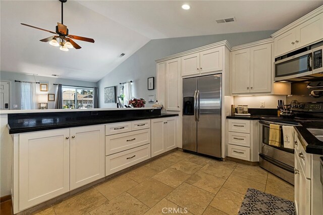 13 Avante Way, Chico, CA 95973 - kitchen with appliances with stainless steel finishes, vaulted ceiling, a peninsula, ceiling fan, and dark countertops