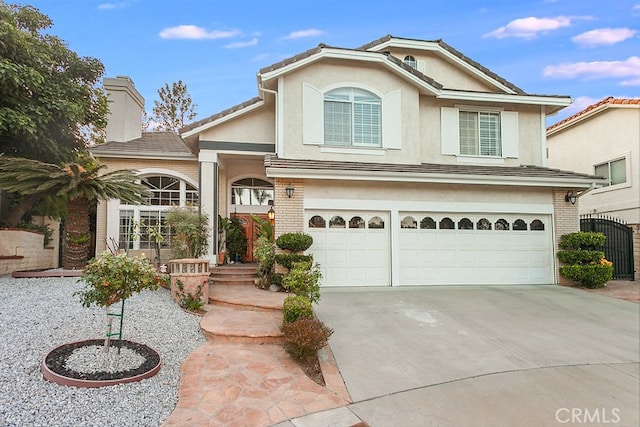17910 Montague Ct, Granada Hills, CA 91344 - view of front of home with a garage, driveway, brick siding, and stucco siding