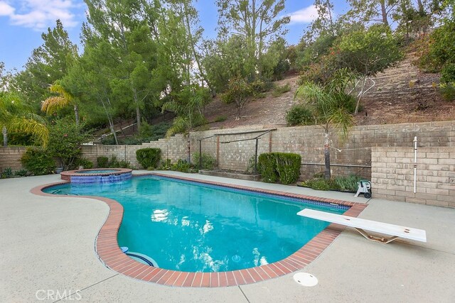 17910 Montague Ct, Granada Hills, CA 91344 - view of swimming pool featuring a fenced backyard, a patio, a diving board, and a pool with connected hot tub