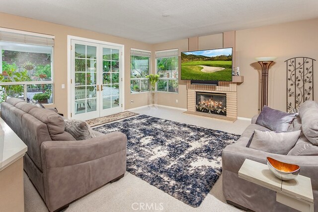 17910 Montague Ct, Granada Hills, CA 91344 - carpeted living room featuring french doors, a brick fireplace, and baseboards