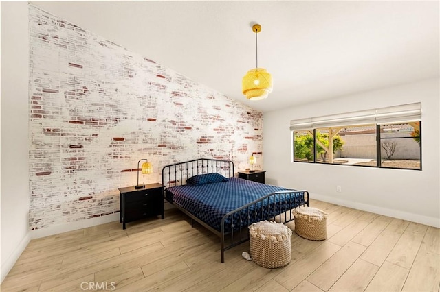 1491 N Omalley Way, Upland, CA 91786 - bedroom with wood finished floors, baseboards, brick wall, and vaulted ceiling
