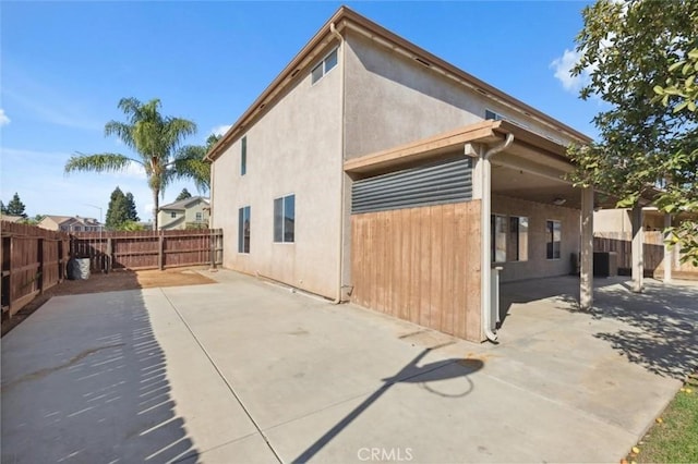 7538 N Erie Ave, Fresno, CA 93722 - view of property exterior with a fenced backyard, a patio area, and stucco siding