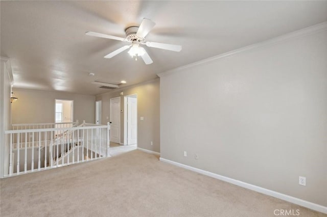 7538 N Erie Ave, Fresno, CA 93722 - spare room featuring crown molding, ceiling fan, baseboards, and light colored carpet