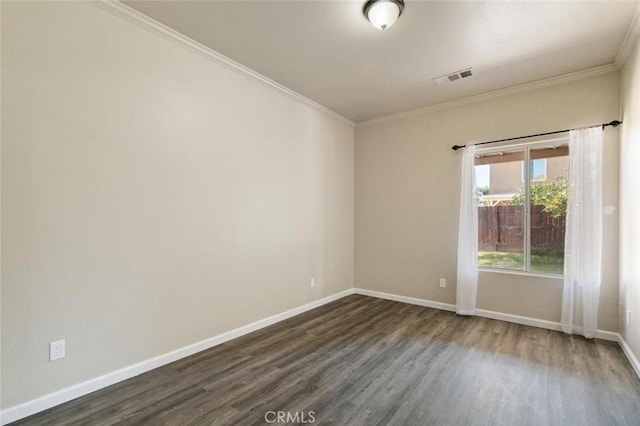 7538 N Erie Ave, Fresno, CA 93722 - spare room with dark wood-style floors, ornamental molding, and baseboards