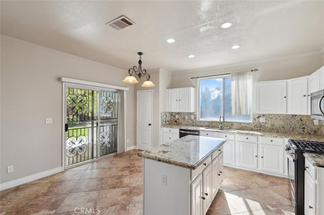7538 N Erie Ave, Fresno, CA 93722 - kitchen featuring stainless steel appliances, ornamental molding, a sink, backsplash, and light stone counters